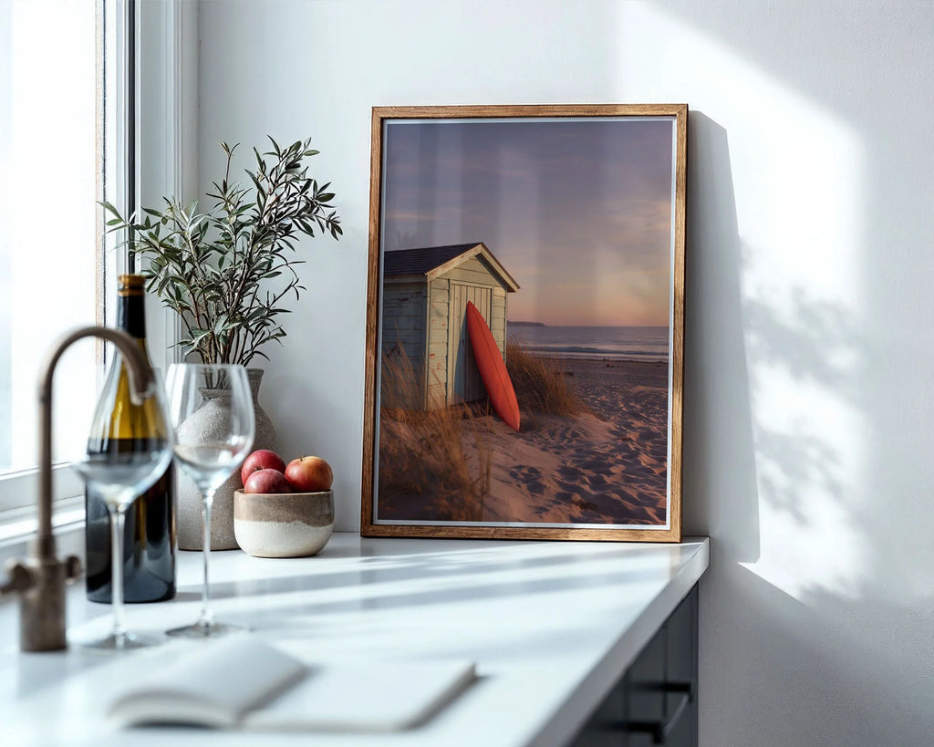 Framed Poster A4 Classic Wood - Beach hut with surfboard at golden hour with soft pastel sky reflecting over calm ocean waters