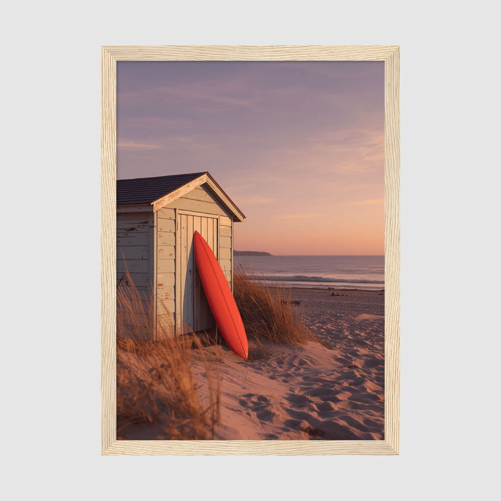 Framed Poster A2 Classic Wood - Serene seaside landscape showing red surfboard propped against hut during warm peachy-orange sunset